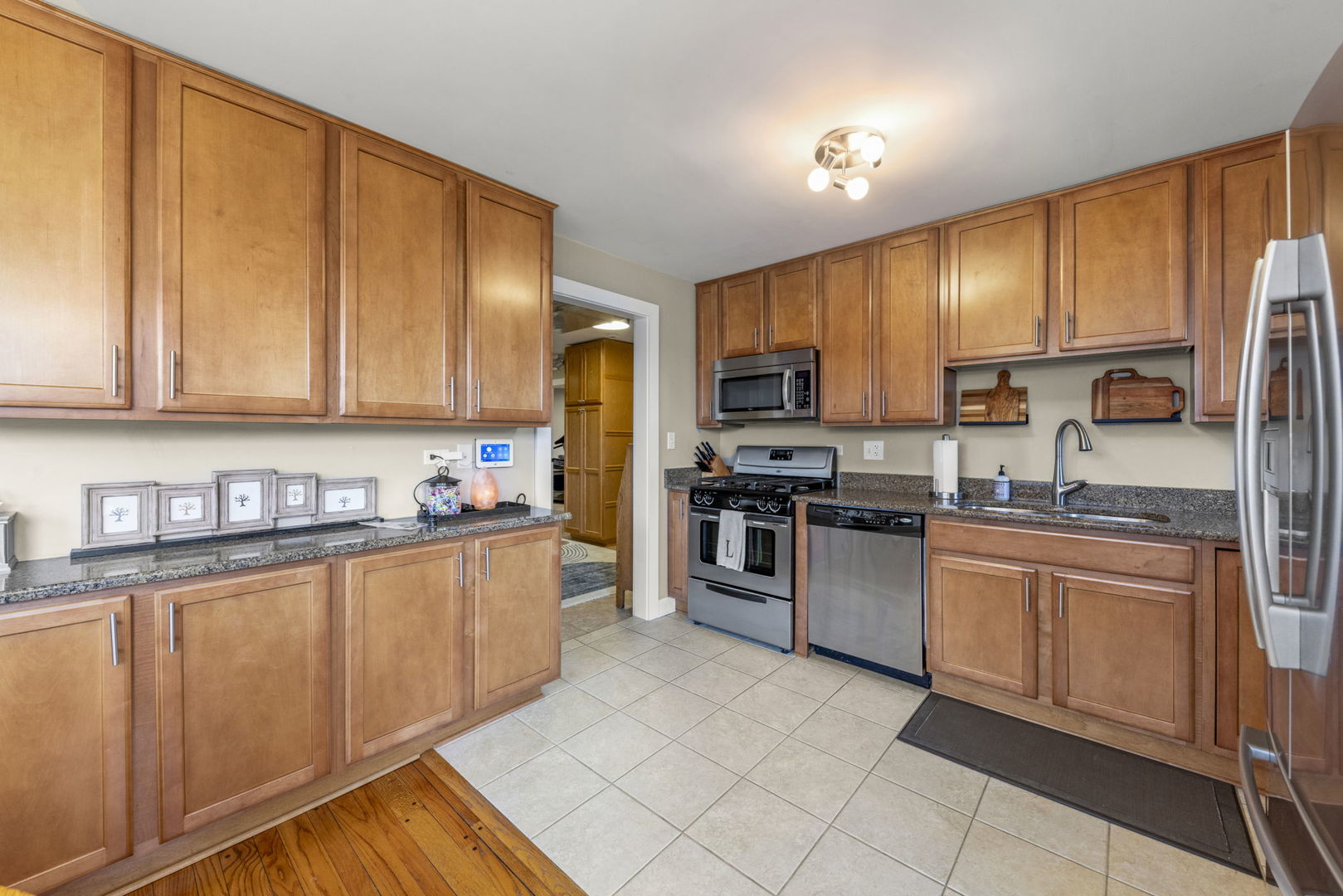 1001 Geneva Road St. Charles, IL 60174 - Photo 6 of 25 a kitchen with stainless steel appliances granite countertop a stove top oven a sink and dishwasher