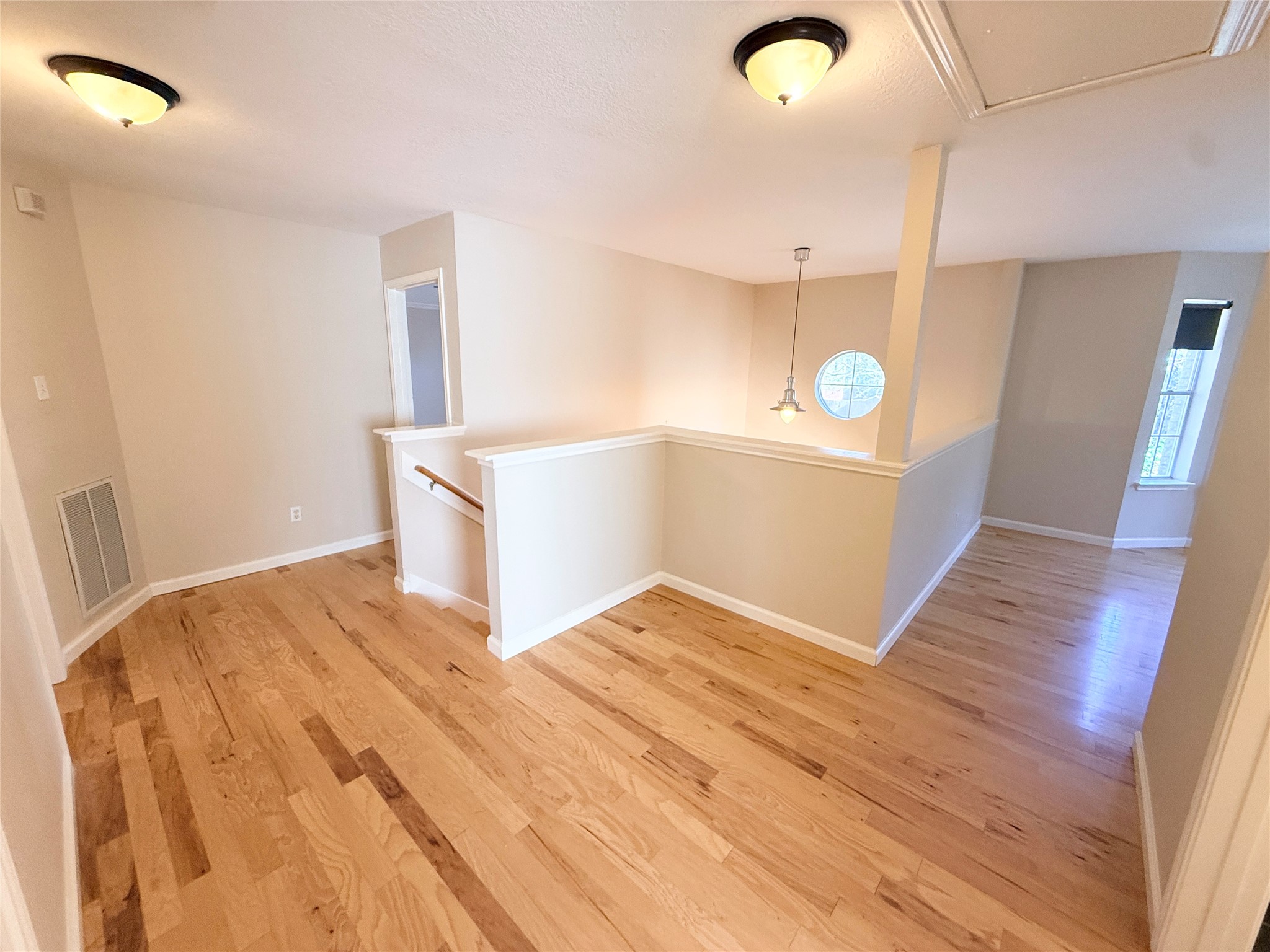 245 North Ranch House Road Angleton, TX 77515 - Photo 10 of 19 A bright and airy landing at the top of the stairs is perfect for a cozy home office setup.