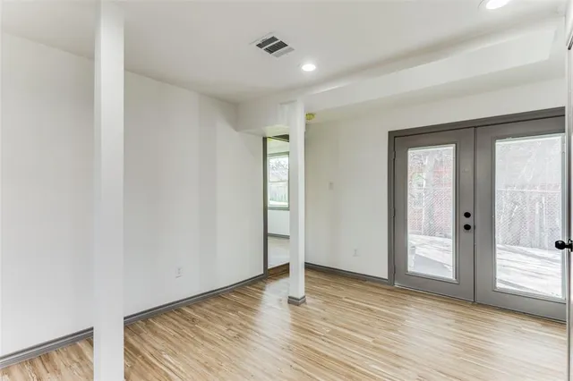 a view of empty room with wooden floor