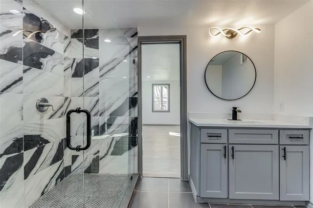 a bathroom with mirror a sink and a mirror