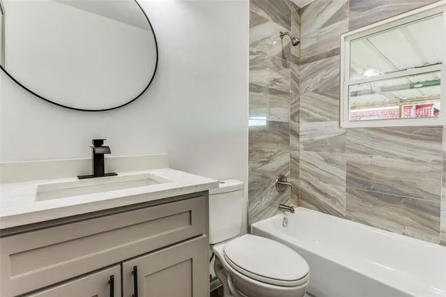 a bathroom with a sink a toilet and a bathtub