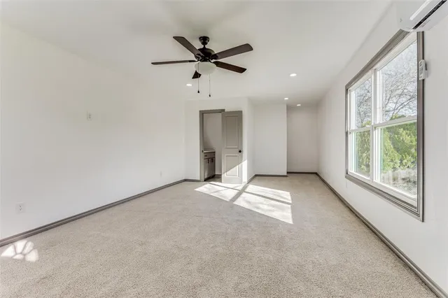 a view of a livingroom with a ceiling fan and window