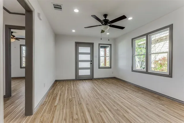 wooden floor in an empty room with a window