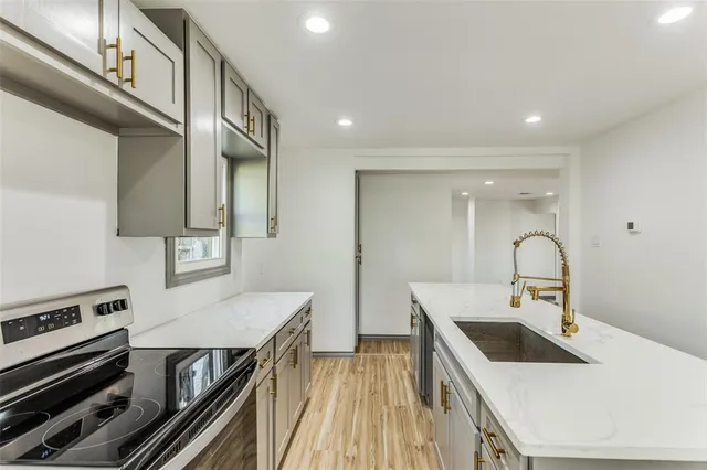 a kitchen with a stove and a sink