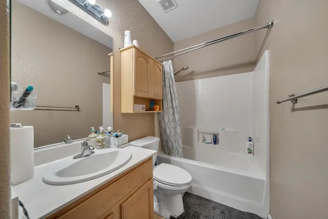 a bedroom with a bed and a night stand