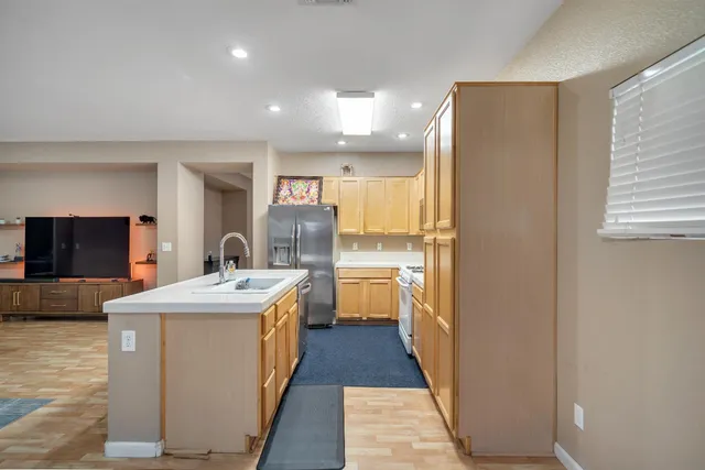 a kitchen with a stove a sink and a refrigerator