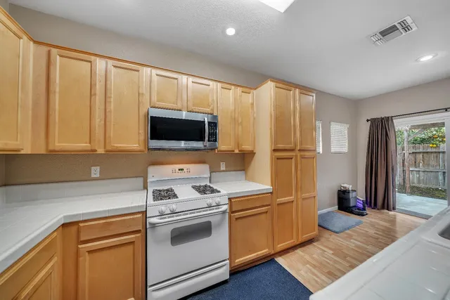 a view of a house with backyard porch and sitting area