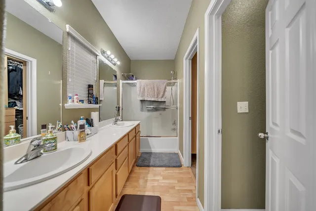 a view of a backyard with wooden fence and a bench