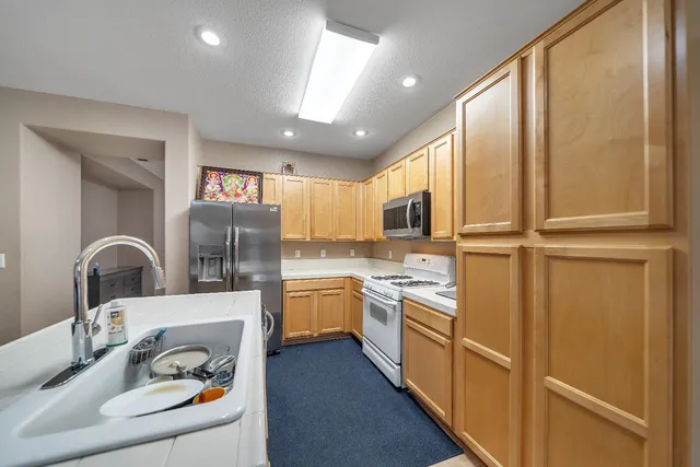 a bedroom with a large bed and a chandelier