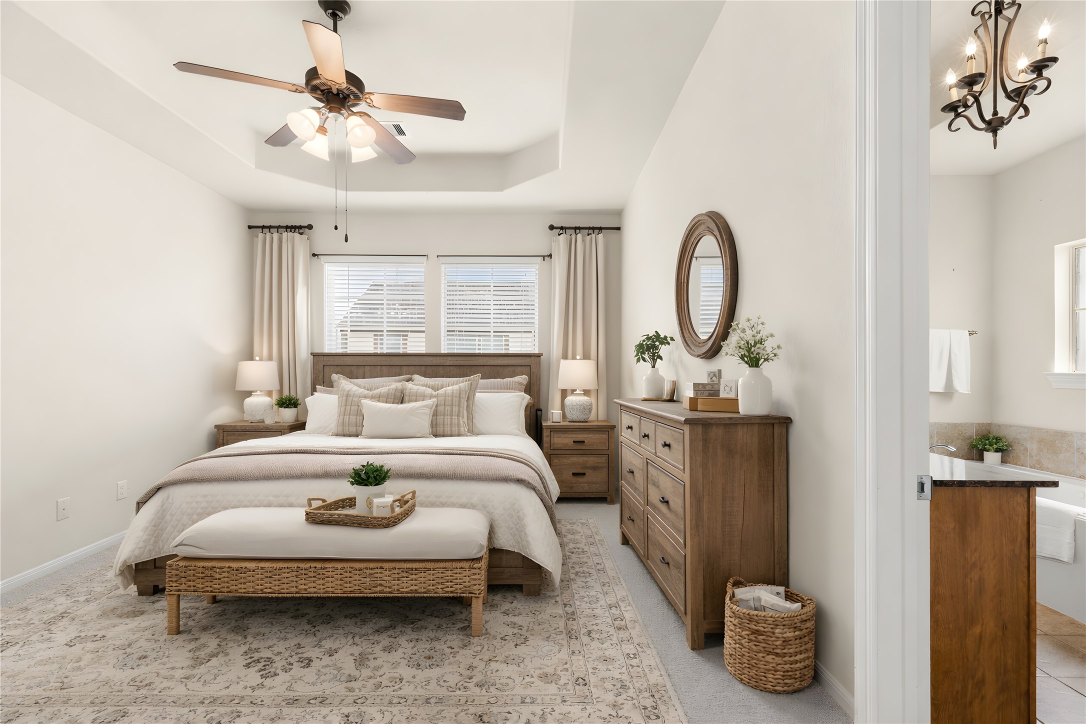 3334 Clearview Villa Way Houston, TX 77025 - Photo 15 of 35 This spacious, light-filled room features neutral walls and carpeting, a ceiling fan, and a view of the adjacent bathroom with a stylish chandelier and soaking tub. Ideal for relaxing after a long day.