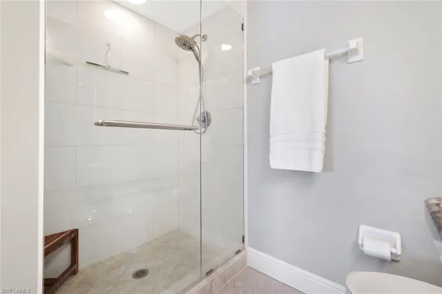 a bathroom with a shower a toilet and sink