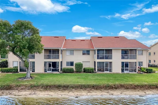 a view of a house with a garden and yard