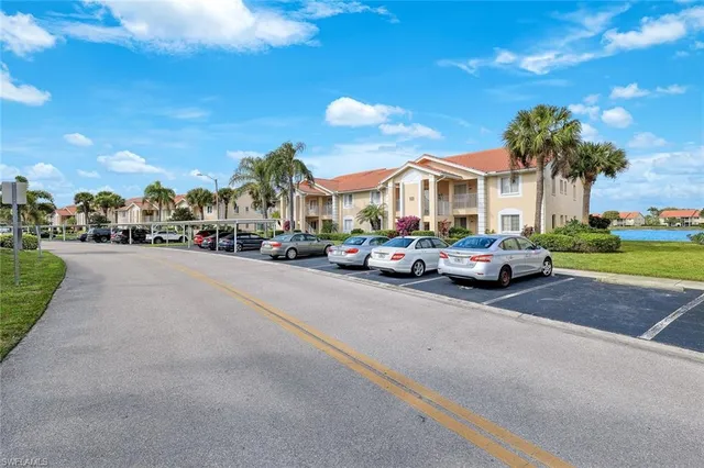 a city street lined with parked cars and buildings