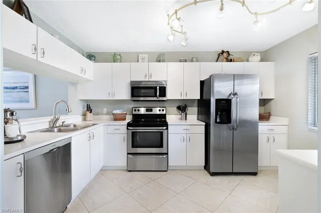 a kitchen with stainless steel appliances a stove sink and microwave