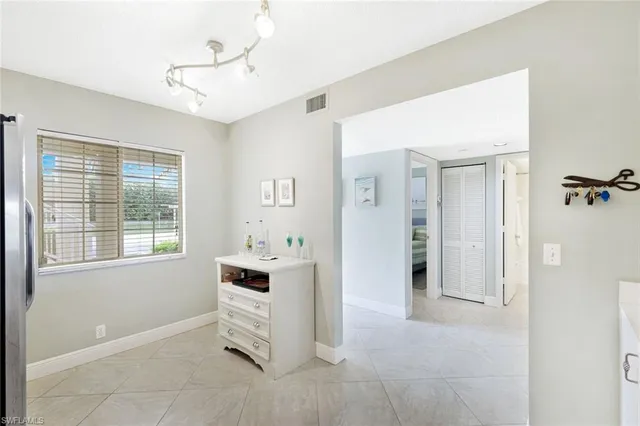 a room with a window and a dresser