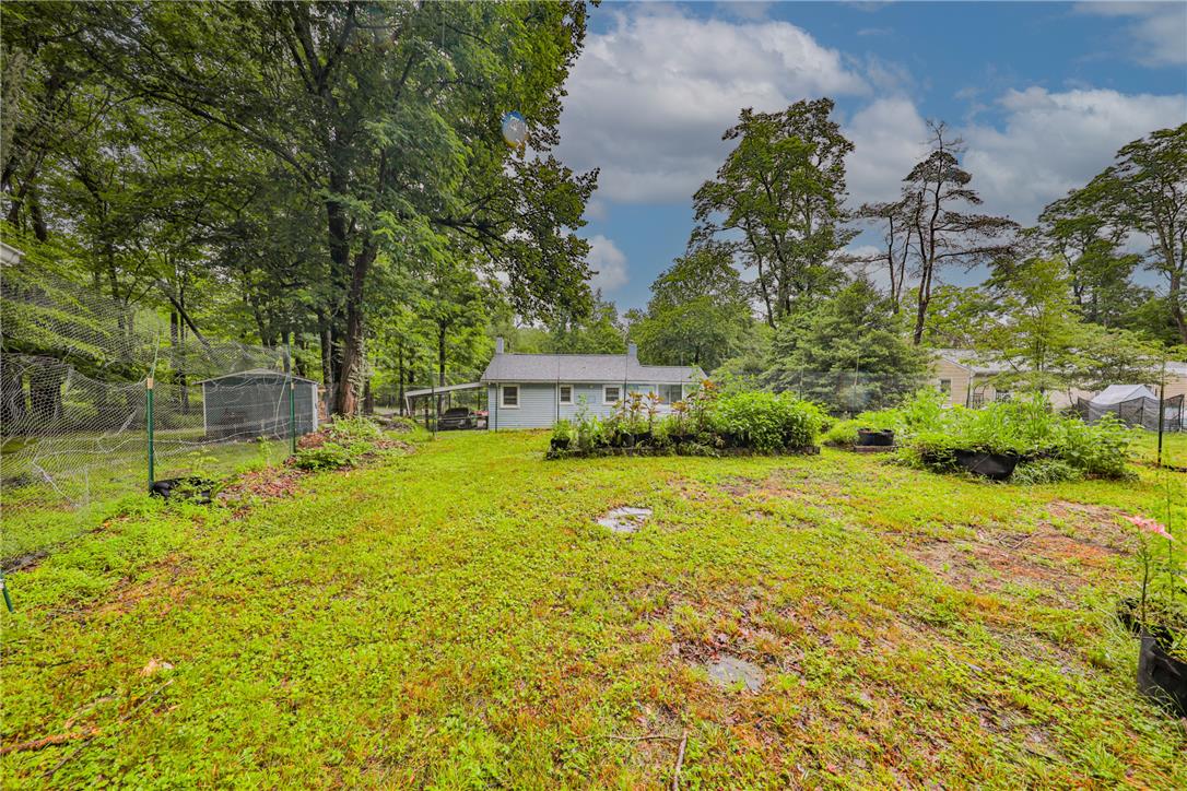 5599 Minks Pond Road Bushkill, PA 18324 - Photo 64 of 64 A tranquil backyard offers ample space and lush greenery for outdoor enjoyment.
