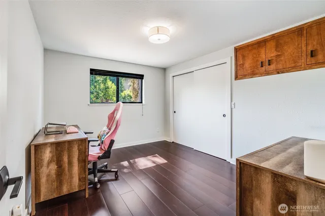 a view of a workspace with furniture and a window