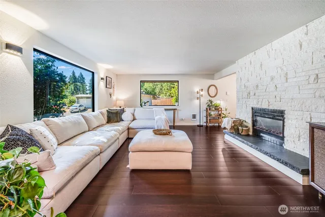 a living room with furniture fireplace and window