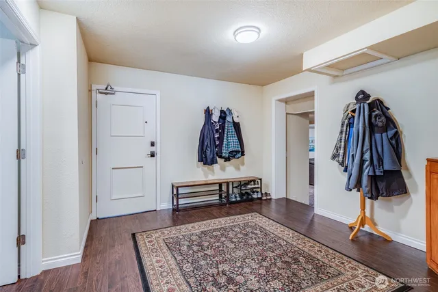 a view of a room with lots of furniture and wooden floor