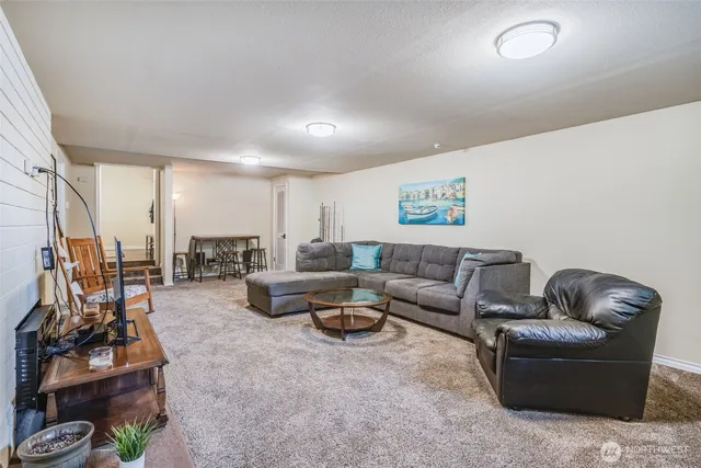 a living room with furniture a couch and large window