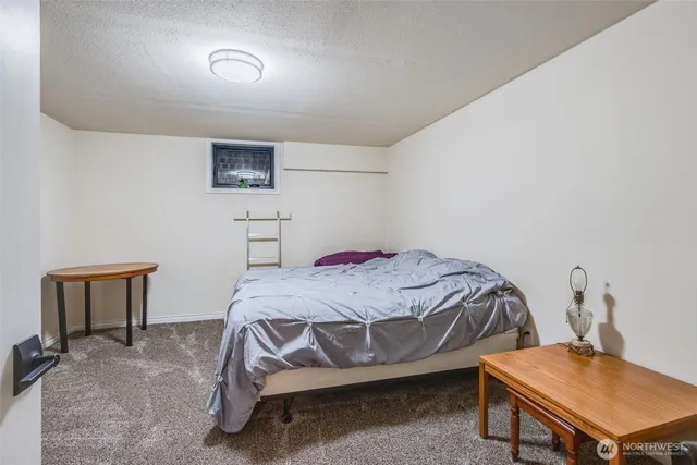 a bedroom with a bed and a table in it