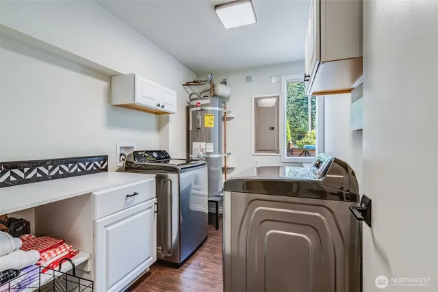 a utility room with sink dryer and washer