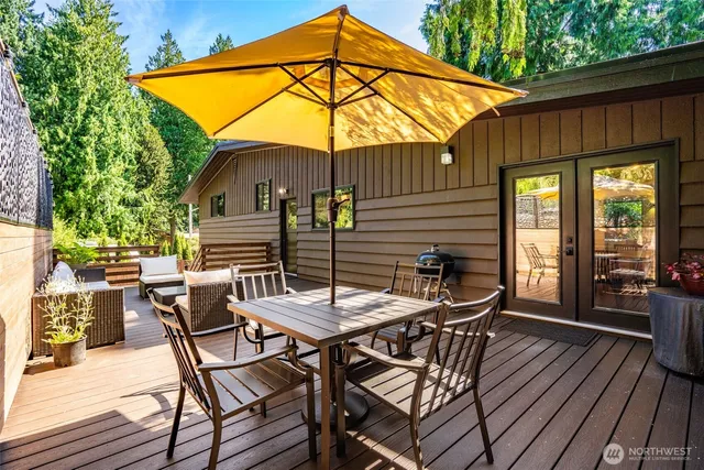 a outdoor living room with furniture and a wooden floor