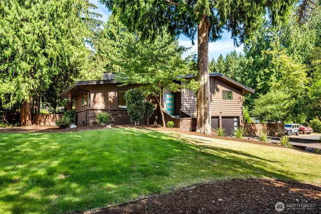 a view of a house with a tree in the background
