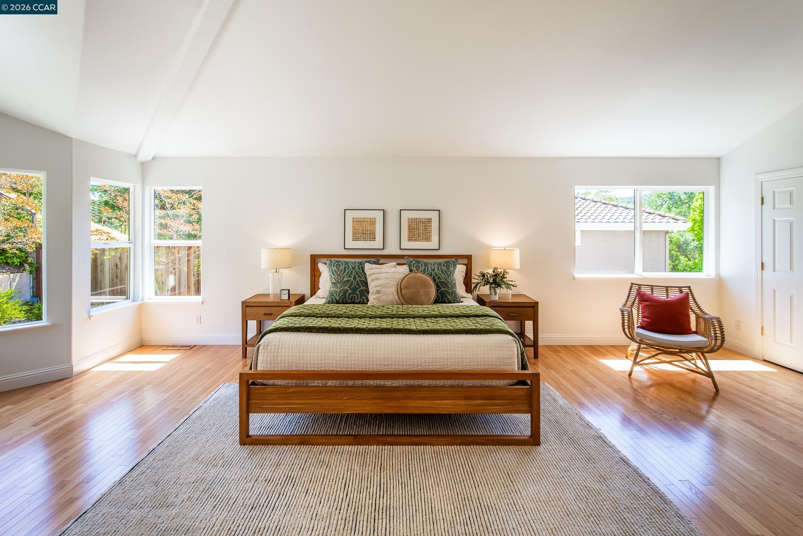 1170 Sunrise Ridge Drive Lafayette, CA 94549 - Photo 23 of 45 a spacious bedroom with a bed a table chair and a large window
