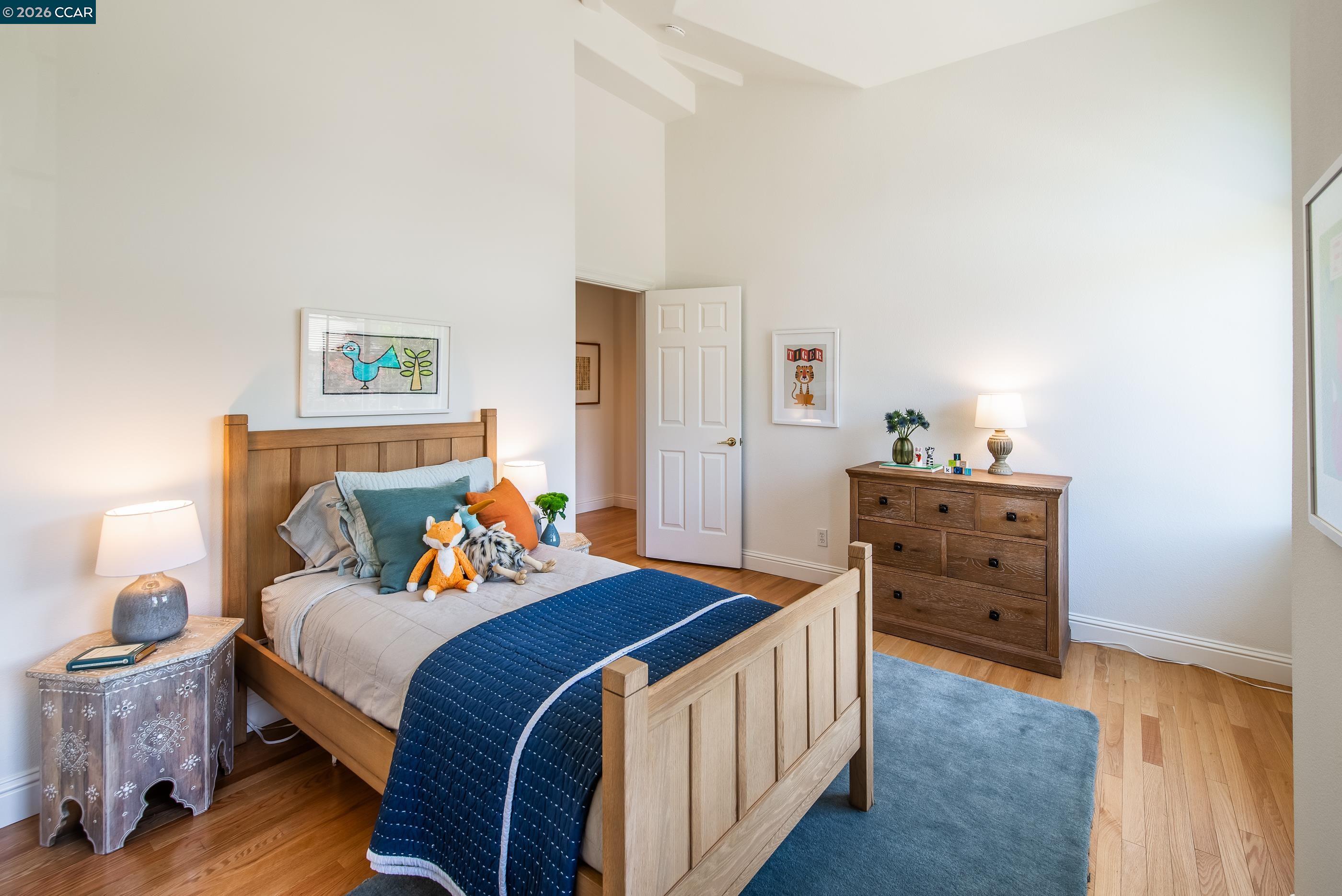 1170 Sunrise Ridge Drive Lafayette, CA 94549 - Photo 34 of 45 a bedroom with a bed and wooden floor