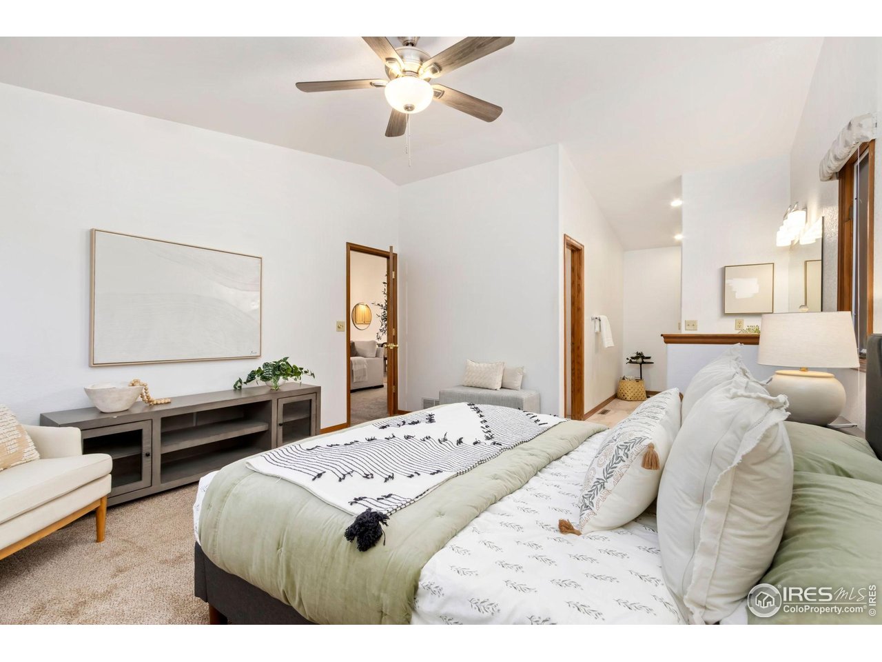 1531 West Swallow Road, Unit 25 Fort Collins, CO 80526 - Photo 15 of 39 Vaulted ceilings in primary bedroom with ensuite bath and walk-in closet