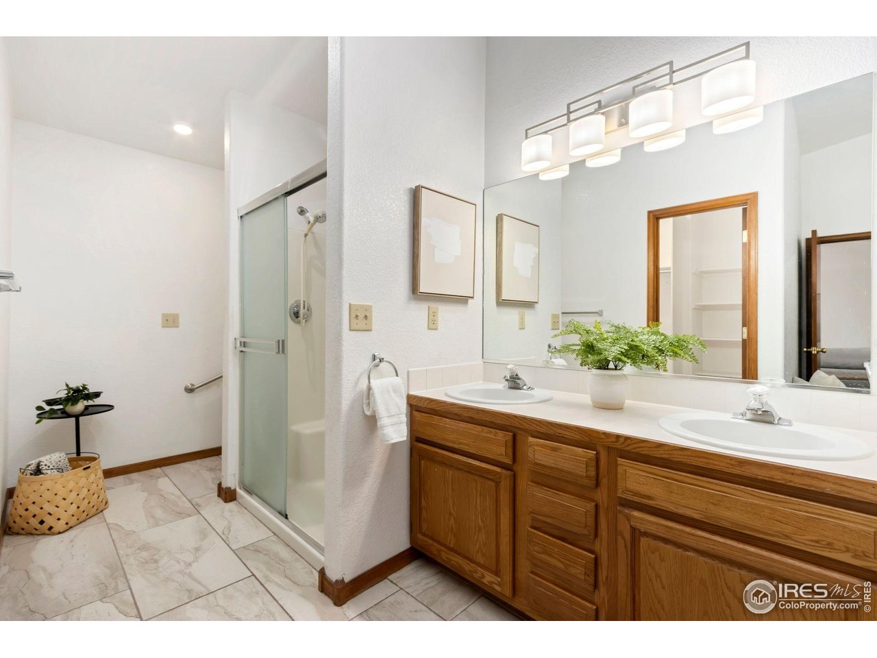 1531 West Swallow Road, Unit 25 Fort Collins, CO 80526 - Photo 17 of 39 Dual vanity and primary bathroom with walk-in closet