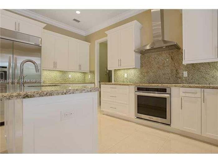 a kitchen with granite countertop a stove and a sink