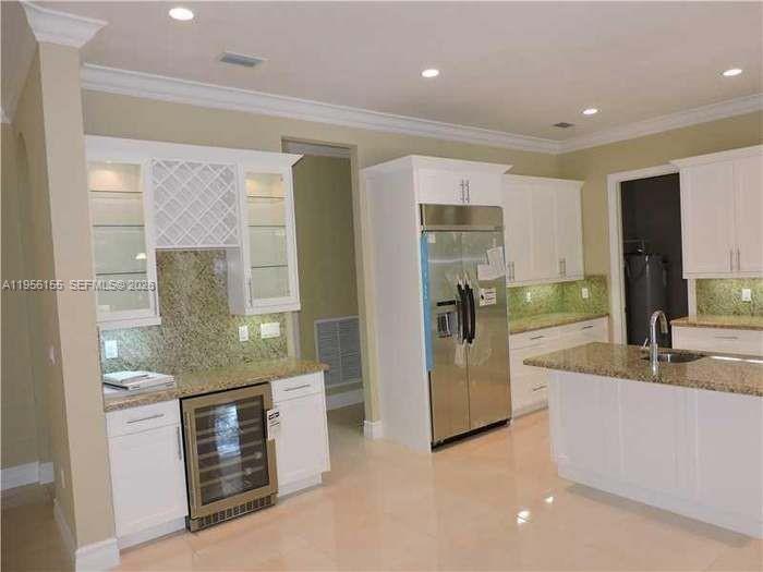 28860 Southwest 182nd Avenue Homestead, FL 33030 - Photo 2 of 15 a kitchen with stainless steel appliances granite countertop a sink and a refrigerator