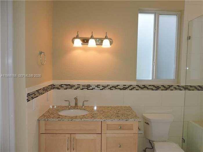 28860 Southwest 182nd Avenue Homestead, FL 33030 - Photo 10 of 15 a bathroom with a granite countertop sink a mirror and shower