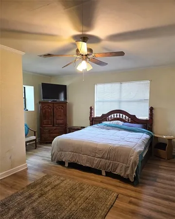 a bedroom with a bed and a chandelier