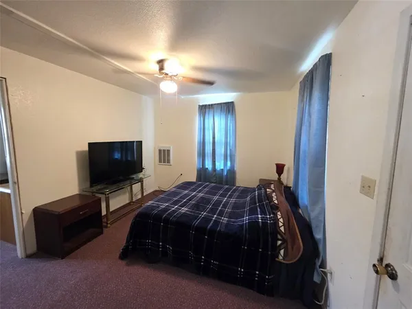 a living room with furniture and a ceiling fan