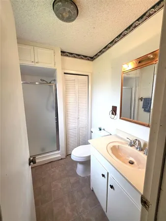 a view of bathroom with a toilet sink and mirror