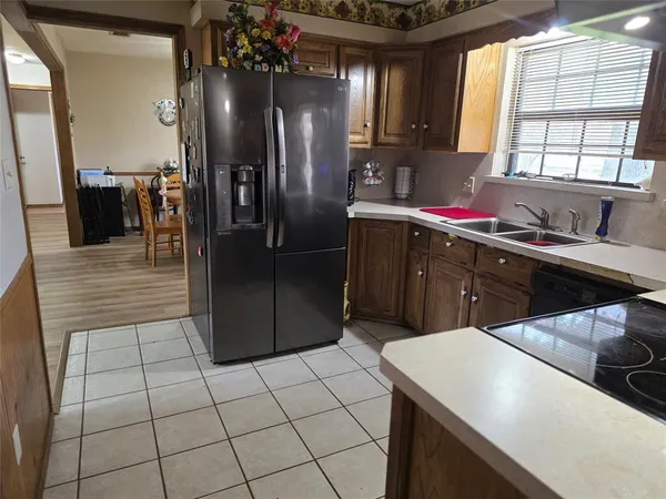 a kitchen with a sink a stove and cabinets