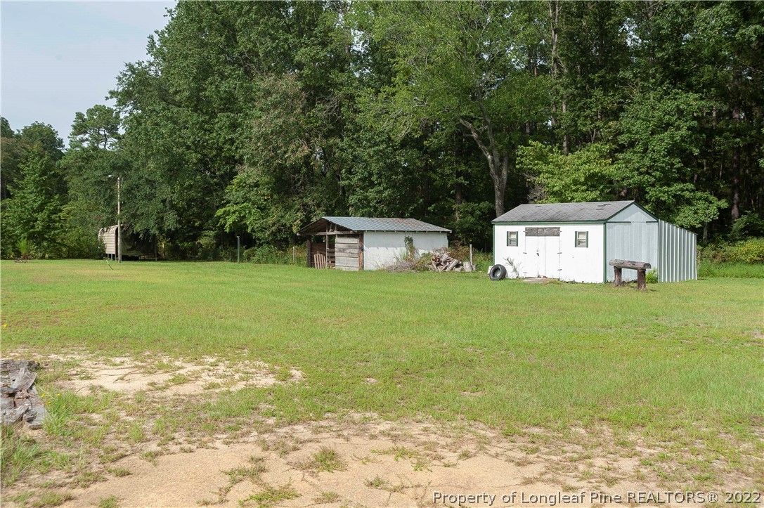 3726 Hayfield Road Wade, NC 28395 - Photo 30 of 50 a front view of a house with garden