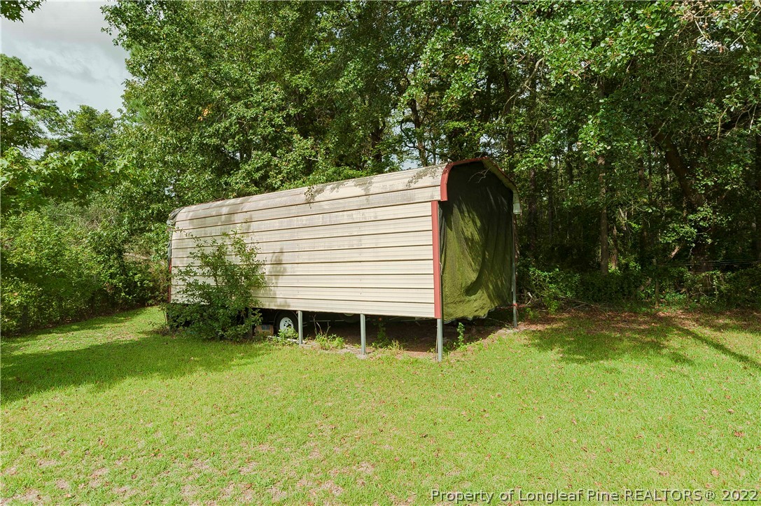 3726 Hayfield Road Wade, NC 28395 - Photo 38 of 50 a backyard of a house with table and chairs
