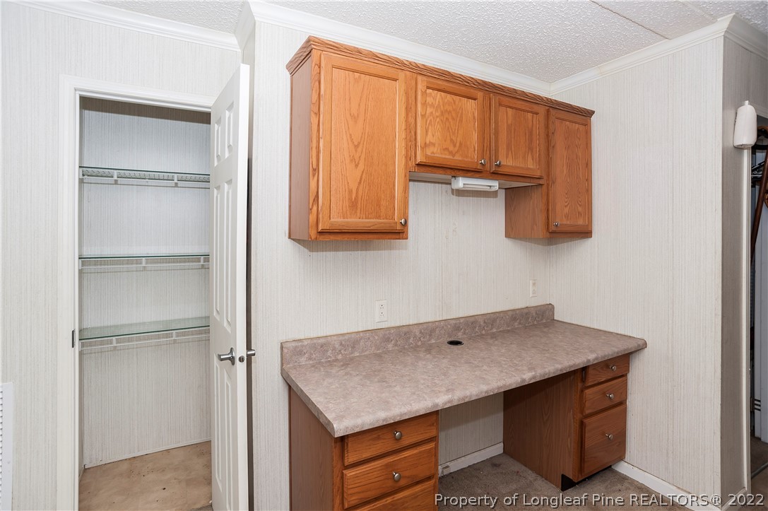 3726 Hayfield Road Wade, NC 28395 - Photo 7 of 50 a kitchen with a refrigerator and cabinets