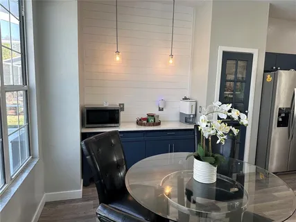 a dining room with furniture and potted plant