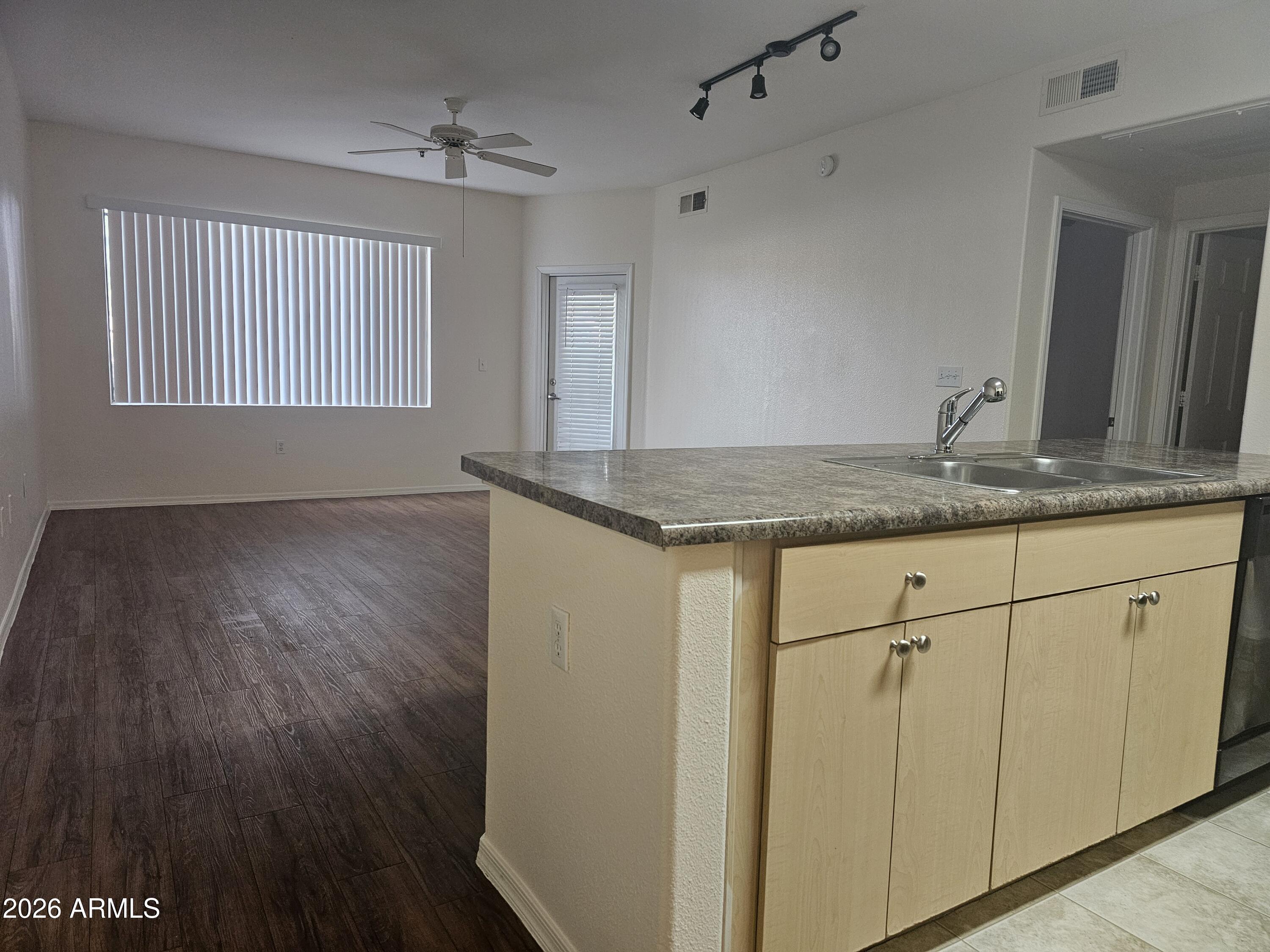 18416 North Cave Creek Road, Unit 1041 Phoenix, AZ 85032 - Photo 2 of 13 a view of a kitchen counter space a sink and a window