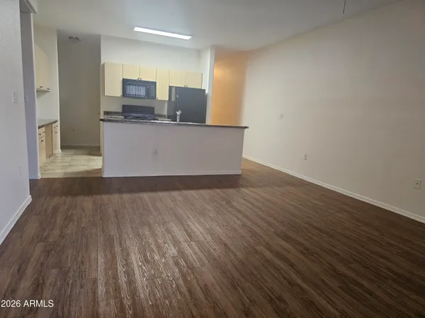 a view of kitchen with cabinets and wooden floor