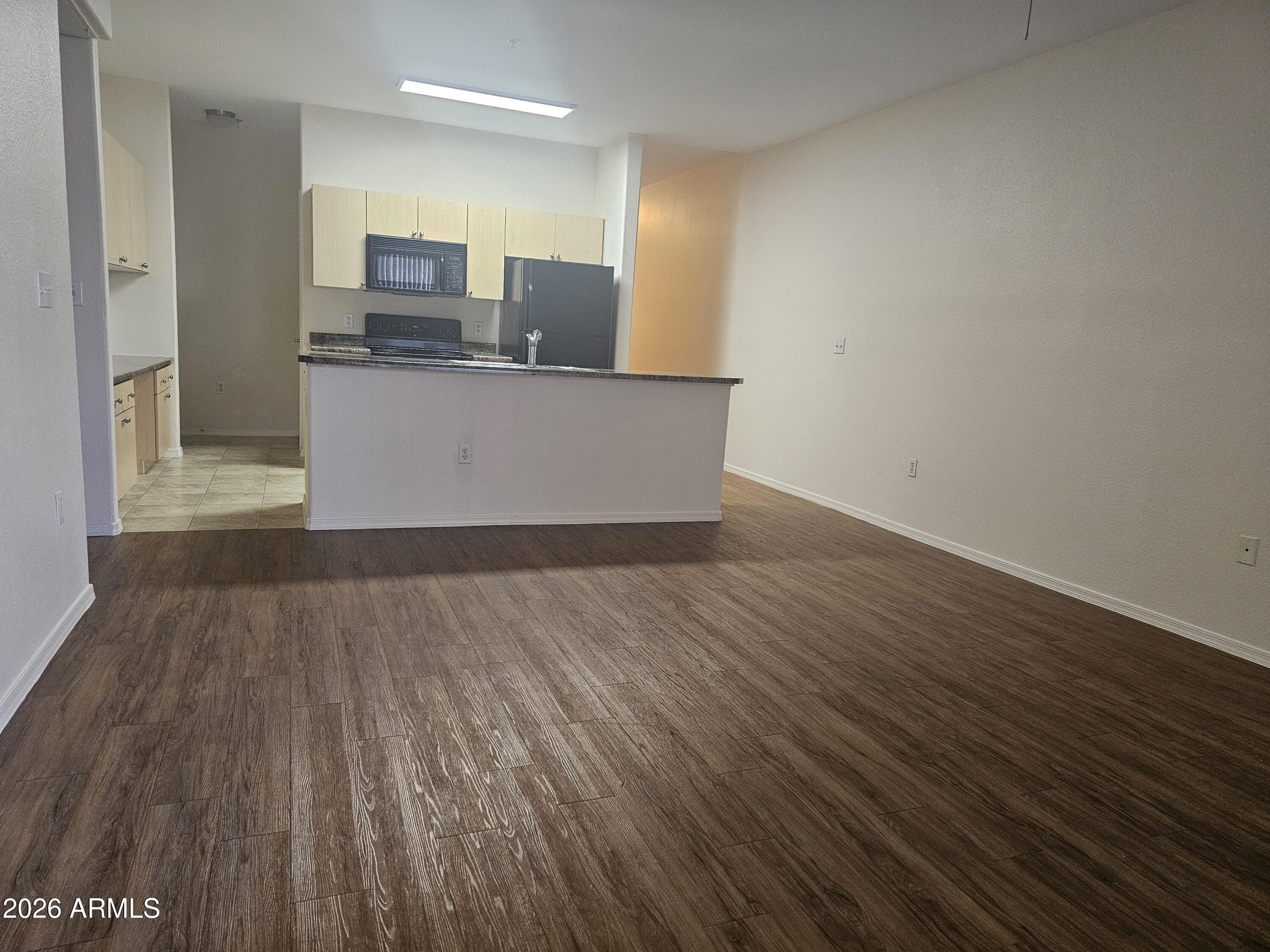 18416 North Cave Creek Road, Unit 1041 Phoenix, AZ 85032 - Photo 5 of 13 a view of kitchen with cabinets and wooden floor