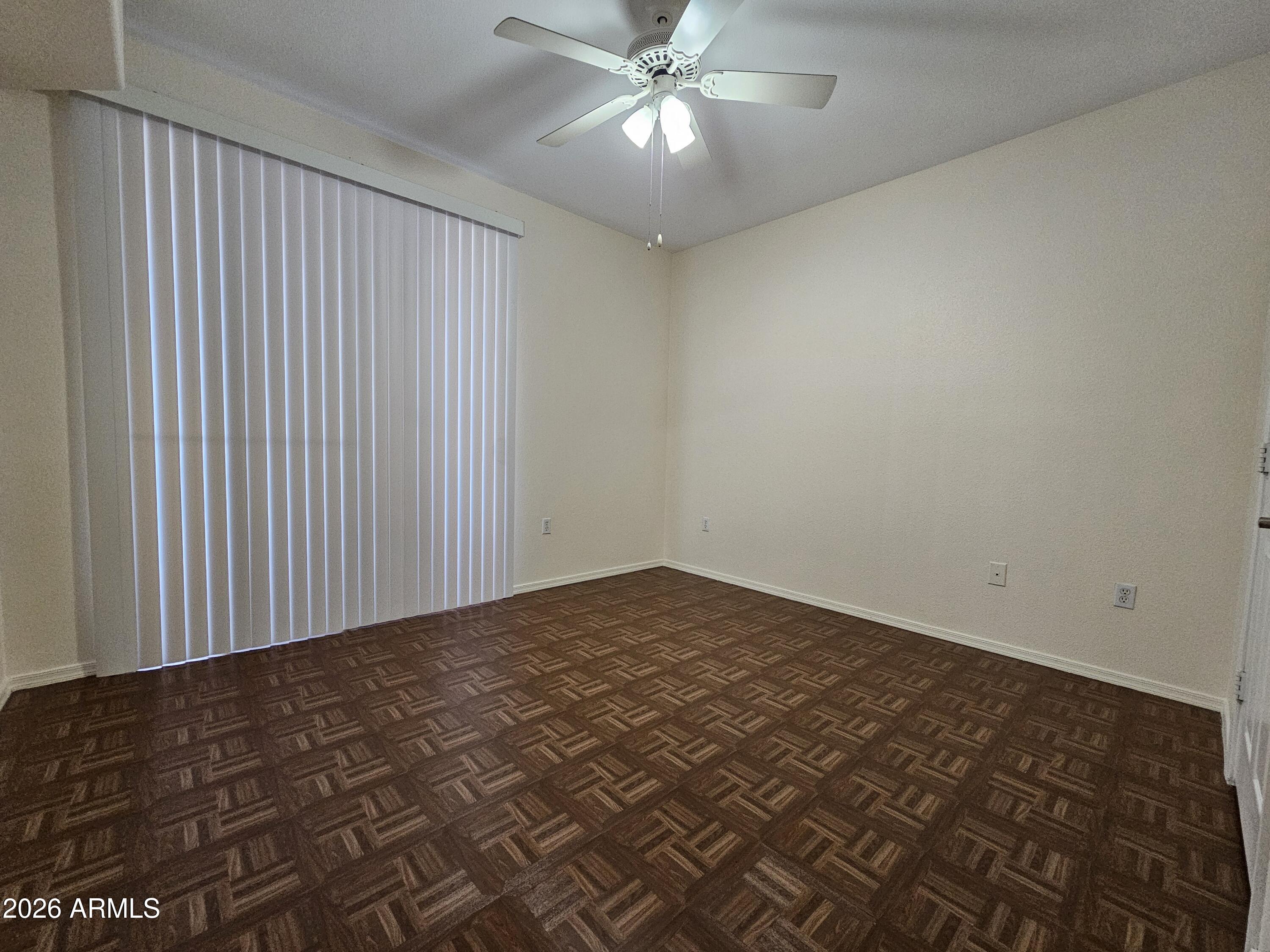 18416 North Cave Creek Road, Unit 1041 Phoenix, AZ 85032 - Photo 6 of 13 an empty room with a ceiling fan and window