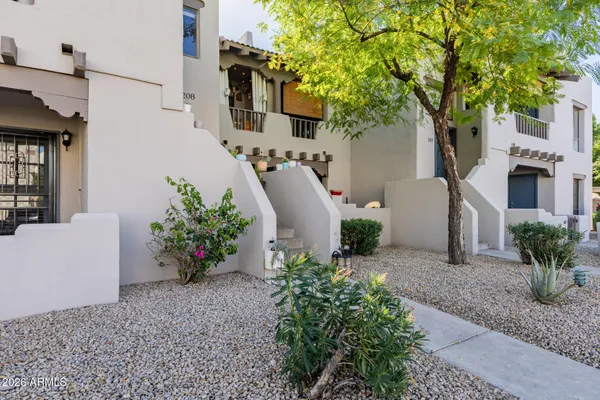 a view of a house with a backyard and a garden
