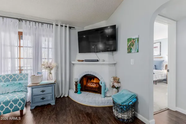 a dining room with furniture a chandelier and wooden floor