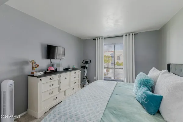 a bathroom with a granite countertop sink a mirror and shower